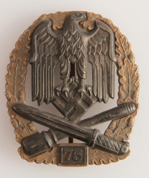 WWII GERMAN THIRD REICH 75TH GENERAL ASSUALT BADGE: German World War II ‘75’ General Assault badge. The reverse side is maker marked ‘JFS’. Has a "coke bottle" pin back. Two piece construction with four rivets on the reverse. Awarded for 75 com