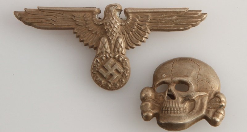WWII THIRD REICH GERMAN WAFFEN SS VISOR INSIGNIA: German World War II Waffen SS Officers Visor Cap Eagle & Skull. Both pieces are maker marked ‘RZM M1/52’. They have two flat horizontal prongs on the reverse side. Stamped silver plated nickel con