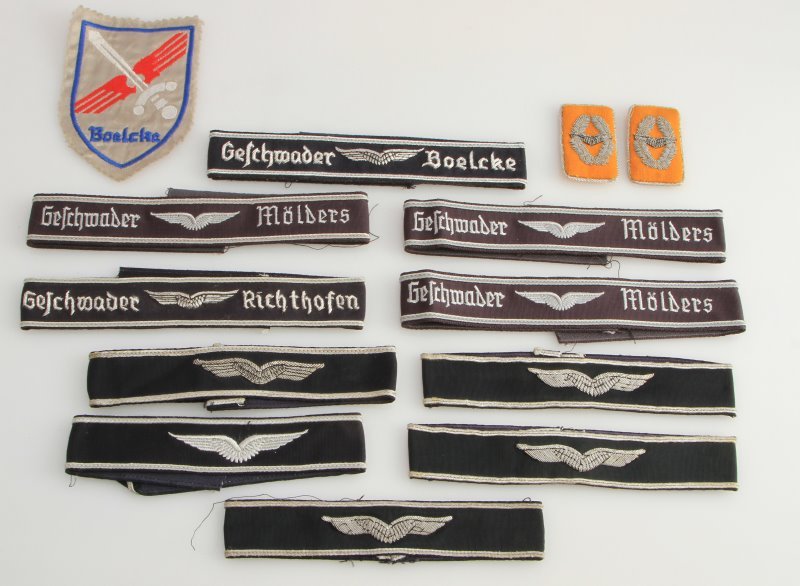 10 POST WAR CUFF TITLES AND COLLAR TABS LUFTWAFFE: Lot of ten post-WWII Luftwaffe style officers cuff titles, a set collar tabs, and a Boelcke patch. Included are a combination of silver bullion wire embroidered cuff titles and embroidered cuff titles