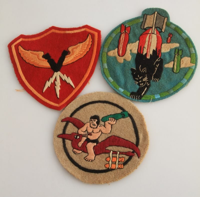 LOT OF THREE WWII US BOMB SQUADRON PATCHES: Three WWII Bomb Squadron patches, including a Marines patch, a 407th Bomb Squadron and an unidentified patch. They measure approximately 5 1/4" in diameter. Minor details fluoresce under black light, 
