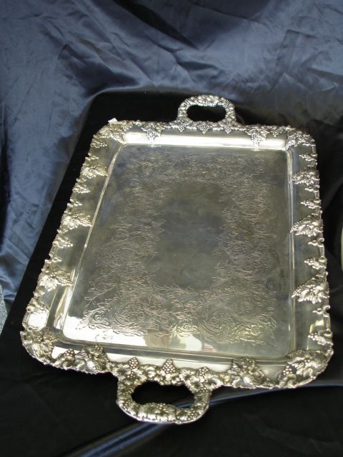 LARGE GRAPE VINE WREATHED HANDLED SILVER TRAY: 28"X 17" SILVER TRAY STANDS ON 4 FEET, ENGRAVED PATTERNING INSIDE BACK HAS 1232 - JIEUR DE LIS, CROWN + LION MARKINGS. PLEASE SEE PICTURES FOR MORE DETAILS AND EMAIL US IF YOU HAVE ANY QUESTIONS.