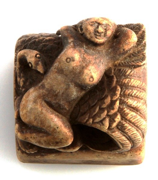 A CHINESE CARVED SEAL WITH A SWAN AND A NUDE WOMAN: A carved stone stamp depicting a nude woman reclining on a swan. Measures 1 3/8 inches wide by 1 3/8 inches deep and 1/38 inches tall. In very good condition with some surface patina.