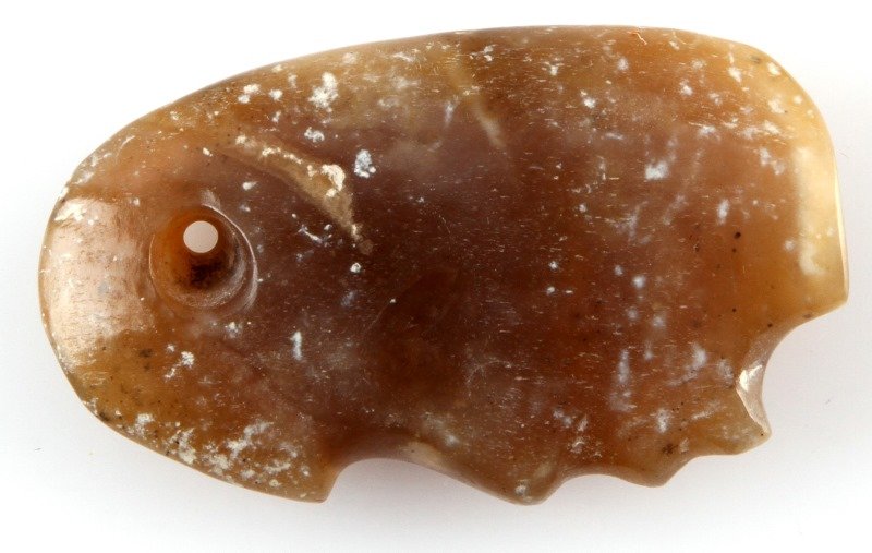 PRE COLUMBIAN BROWN JADE MAYAN KING PENDANT: Rich brown polished jade side view profile pendant, measures two inches and has drilled perforation at top. Louisiana Merchant Marine collection recovered prior to 1950, in the Belize, New River regio