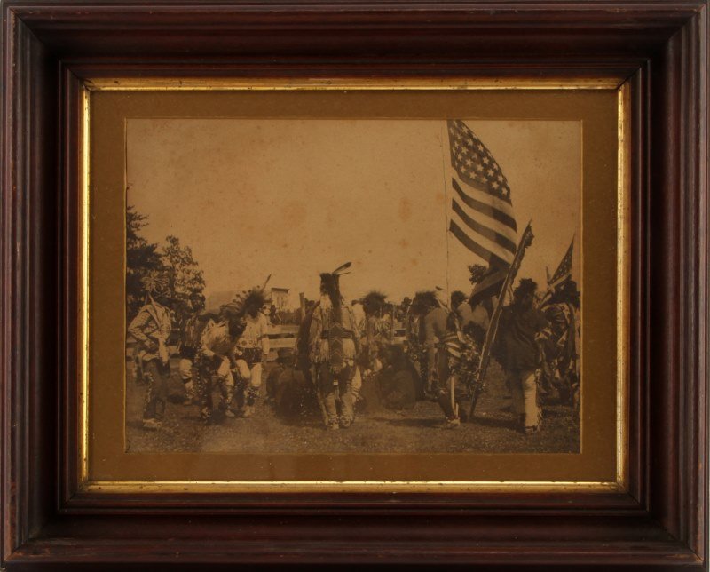 1900 PLAINS INDIAN ANTIQUE PHOTOGRAPH DANCING: Grouping of Plains Indians appearing to be dancing possibly a Fourth of July celebration, the flag is a 45 star flag dating this photo 1896 to 1908. The photograph measures in the frame 13 by 10, the