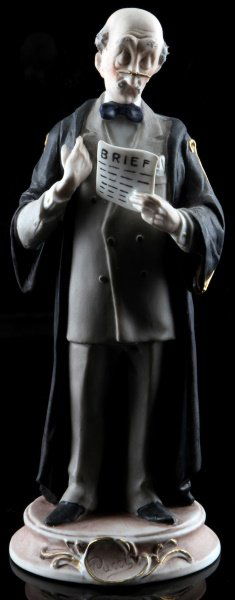 CAPODIAMONTE LAWYER FIGURINE BISQUE 10 INCHES TALL: Retired Capodimonte bisque figurine of a lawyer, designed by Pucci. The underside is marked with the Capodimonte emblem. The figure is in very good condition with no chips, cracks, or crazing. Measure