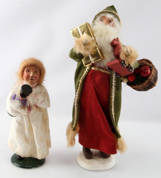 BYER'S CHOICE 1993 SANTA & MARIE 1ST ED. CAROLERS: Byer's choice St. Nicholas Santa with presents robe & gown and 1993 first edition Marie in white dress holding nutcracker. Items are in very good condition with no signs of damage or deterioration. Co
