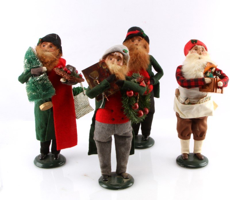 LOT OF FOUR BYERS CHOICE THE CAROLERS DOLLS: One 1997 Man with Christmas Tree, One 1996 Man with Pocket Watch, One 1995 Man with Wreath, One 1996 Man with Box. All good condition with no scratches, chips, or cracks.