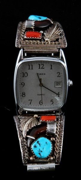 TIMEX WATCH WITH .925 STERLING NAVAJO WATCH BAND: Timex quartz stainless steel timepiece with sterling Navajo end pieces marked "H sterling" a marking of a known Navajo artist; each piece bears a turquoise stone opposite a red stone and leaf with a f