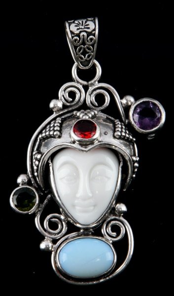 ORNATE STERLING JEWEL FACE RELIEF PENDANT W/ OPAL: Ornate multi jewel encrusted face relief pendant with 3 multi-colored stones and opal. Item is stamped ".925" on the back. Item is in excellent condition with no signs of damage. Tested. Total weight: