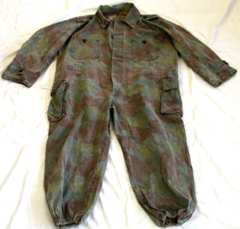 WWII SS PANZER DIVISION M-29 JUMPSUIT COVERALLS: Made of imported Italian cloth assembled in either Germany or Czechoslovakia, dated and numbered with Death Head stamp with wear consistent with the rest of the garment. Has a blue draw string, has an