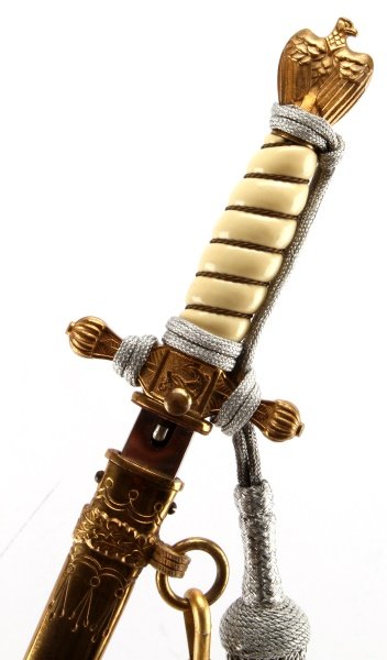 SUPERB WWII GERMAN KREIGSMARINE OFFICERS DAGGER: Near mint condition, etched Eickhorn Solingen blade. Lions head hangers and the silver Tassel Knot , tied in the very difficult sailors knot. Virtually no detractions.This lot has a reserve.