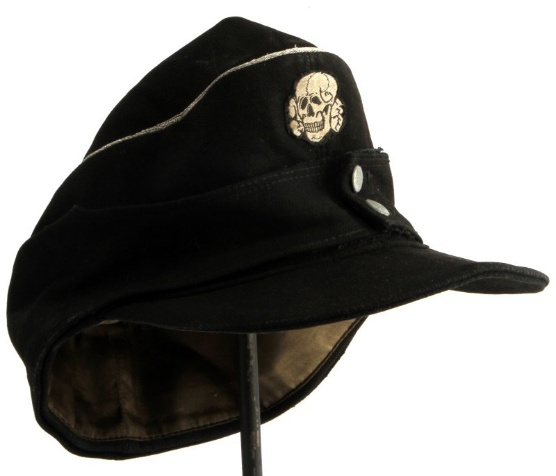 WWII GERMAN SS PANZER M43 FIELD CAP SIZE 56: WWII German SS M43 field cap with green satin lining, leather sweatband, and silver bullion piping. The cap has totenkopf insignia on the front and an SS eagle on the side. The buttons have some wear,