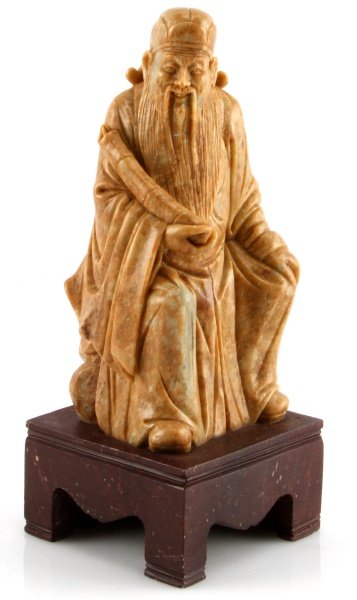 9'' TALL SOAPSTONE CARVING OF SEATED SCRIBE SCROLL: Asian soapstone carving of seated scribe or scholar with scroll in hand, intricately carved with attention to facial detail and posture. Measure 9 inches toll on brown wooden base, in very good condit