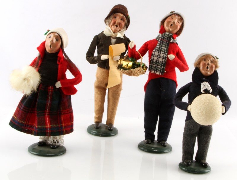 LOT OF FOUR BYERS CHOICE THE CAROLERS DOLLS: Lot of four Byers Choice Caroler dolls. One 1996 Caroler girl with white muff, one 1997 Caroler man with basket of presents, one 1997 Caroler boy with ball, one 1997 Caroler man with sheet music. All 
