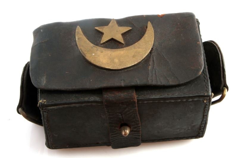 TURKISH AMMO POUCH WITH STAR AND CRESCENT: A Turkish ammo pouch with brass star and crescent from the early 20th century. In very good condition with some wear from age.This lot has a reserve.
