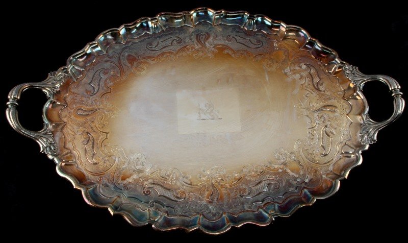 ENGLISH LIVERY LION MARK SILVER PLATE TRAY FOGG: From the estate of Lisbeth Fogg in Camilla, GA. Huge engraved and etched silver plate tray with Livery mark to center (lion holding spear), scalloped edges, and two handles. Marked to back (X and fain