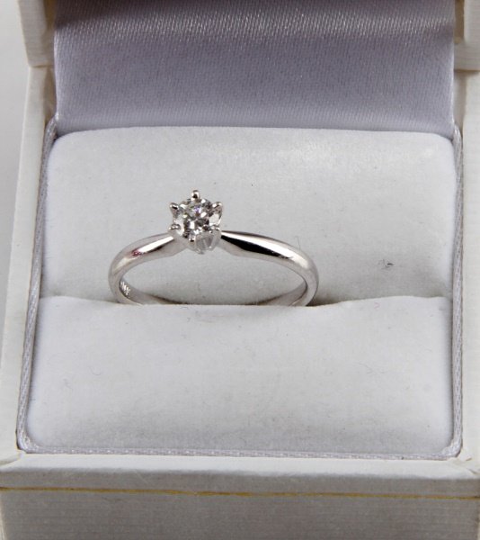 14 KARAT WHITE GOLD SOLITAIRE .29 CT SIZE 7.25: White gold solitaire with .29 carat round brilliant cut diamond. 4.2 mm diameter, 2.4 mm depth, medium girdle. Near colorless F/G stone. Eye clean I1. Clear feather inclusions. Size 7.25. Weighs 2.2 g