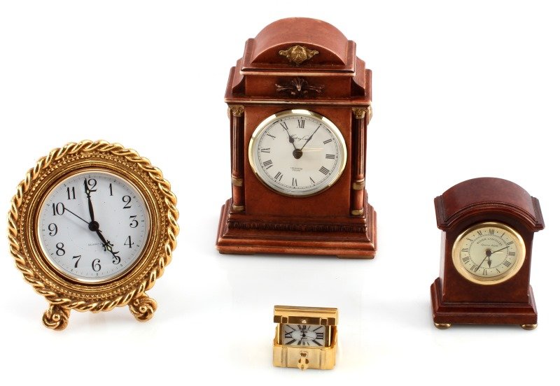 LOT OF 4 SMALL MANTLE CLOCKS HISTORY CRAFT BULOVA: Group of four smaller mantle clocks. The first is a History Craft (England) made of resin, takes a LR1 battery, measures 6.5 by 4.5 inches, "made in Germany" to back plastic piece. The second is made