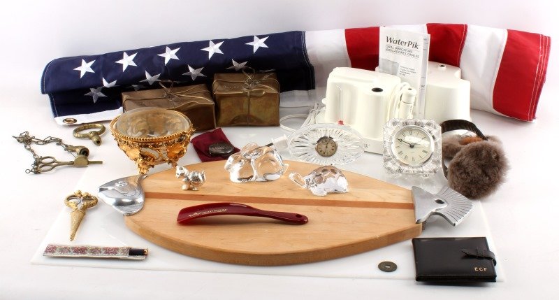 FOGG ESTATE FINDS MIXED LOT BACCARAT FLAG CLOCK: From the estate of Lisbeth A. and Edward C. Fogg, Camilla, GA. Includes: two crystal glass figurines (France), Christople cat figurine, cutting board, signed copper gift boxes, nylon USA flag (34 by 5