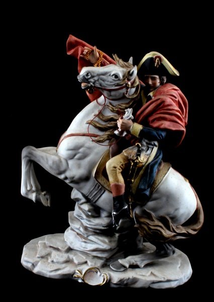 NAPOLEON BISQUE FIGURINE CROSSING ALPS 10" TALL: Vintage bisque figurine sculpted after Santini Pucci. The figurine has signature on the base, and a factory mark on the underside of the base. This figurine depicts Napoleon on horseback, after Jacque