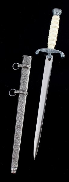 WWII GERMAN 3RD REICH MINIATURE ARMY DAGGER: Dagger measures 71/2" long the blade is 5" long. The crossguard has a eagle holding a swastika inside a wreath. The scabbard has 2 bands with suspension rings. Does not come with hangers or buckles. T