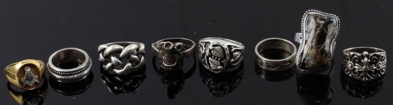 VINTAGE STERLING SILVER RING LOT LARGE SIZE: Lot of seven sterling silver and one 18 kt HGE rings. The golden ring has Masonic insignia on the center. This lot also includes a ring shaped like a horse saddle, size 13. Includes three size 9 rings