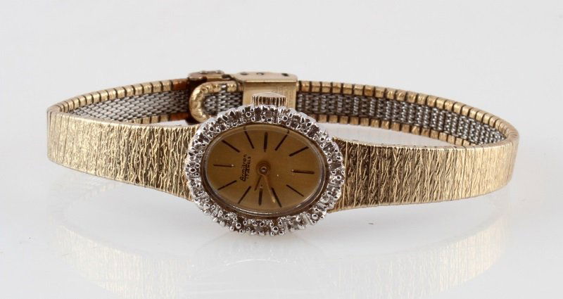 ARMITRON VINTAGE GOLD AND DIAMONDS LADIES WATCH: A vintage ladies Armitron 17 jewel mechanical movement wrist watch. Bezel decorated with diamonds and white gold plated accents. In very good running condition.