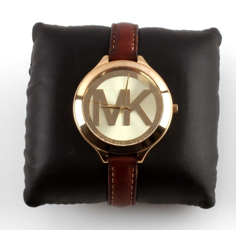MICHAEL KORS SLIM RUNWAY LEATHER STR WATCH MK2326: Ladies' Michael Kors watch with dark slim leather strap, model # MK2326 with gold round face color, analog quartz, water resistant. This casual style watch has one minor scratch at between (2-3) and s