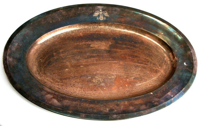 ADOLF HITLER LARGE PLATTER BY WELLNER SILVER PLATE: Large oval serving platter from Adolf Hitler's service. The top of the platter is engraved with the Heer eagle and Hitler's monogram. The back is marked "Wellner 180" and has a serial number on the th