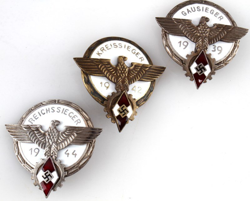 LOT OF 3 HITLERJUGEND HITLER YOUTH BADGES 39 42 44: Grouping of three Hitler Youth badges including; 1939 Gausieger, 1942 Kreissieger and 1944 Reichssieger. Each one of which is maker marked on the bottom. Items are in good condition. Unauthenticated,