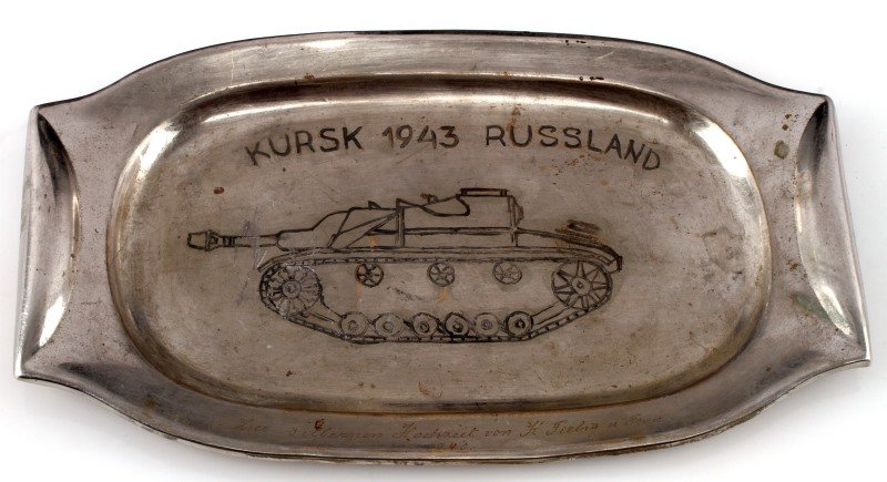 WWII GERMAN PANZER KURST BATTLE PRESENTATION PLATE: WWII German Panzer Kurst battle engraved presentation plate marked "Kursk 1943 Russland" and a smaller much finer engraving on the bottom rim of the plate with "1940" below it. Measures 9 inches in lo