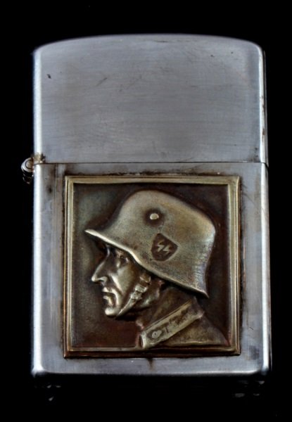 GERMAN NSDAP WERMAKHT FORCES CIGARETTE LIGHTER: WWII German NSDAP Wermakht forces cigarette lighter, roughly same dimensions as a Zippo but bears a relief of a German soldier on front. Item is in good condition, unauthenticated sold as is.This lot 