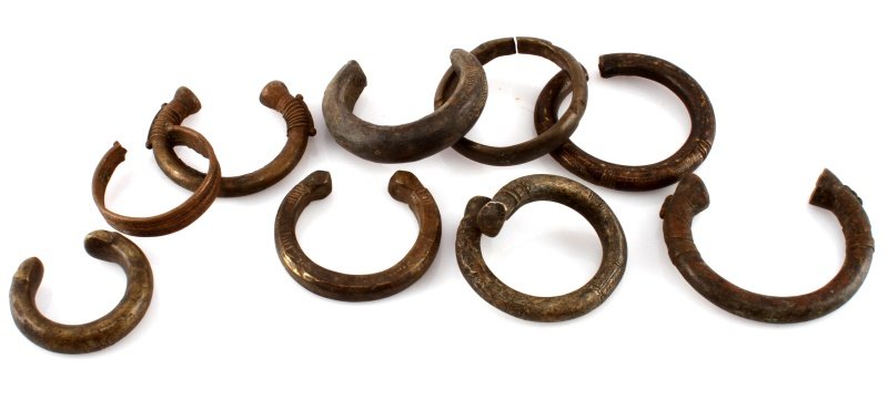 LOT OF NINE AFRICAN BRONZE BRACELETS ANTIQUE: Lot of nine antique West African cuff bracelets in different sizes. Possibly slave manillas from Nigeria. All of the bracelets have subtle engravings near the opening. The largest bracelet measures 6.