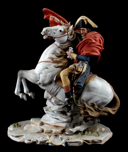 NAPOLEON BISQUE FIGURINE CROSSING ALPS 13" TALL: Vintage bisque figurine sculpted after Santini Pucci. The figurine has signature on the base, and a factory mark on the underside of the base. This figurine depicts Napoleon on horseback, after Jacque
