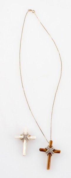 PAIR OF STERLING SILVER CROSSES TIGER EYE & MOP: Lot of two cross pendants and one box link chain in silver. One cross is made from tiger eye and the other is pearl. Marked 925. The crosses measure 1.5 inches long. The chain measures 17.5 inches lon