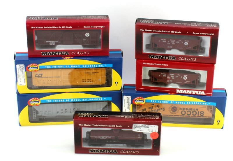 7 PIECE LOT HO SCALE MANTUA & ATHEANN MODEL TRAINS: All are perfect condition still in box. Mantua include 729-620 Heavy 32' Hopper PRR, 36' Hopper with coal PRR, 40' single door tank PRR,41' wood cattle car with sliding door PRR.Atheann include Claren