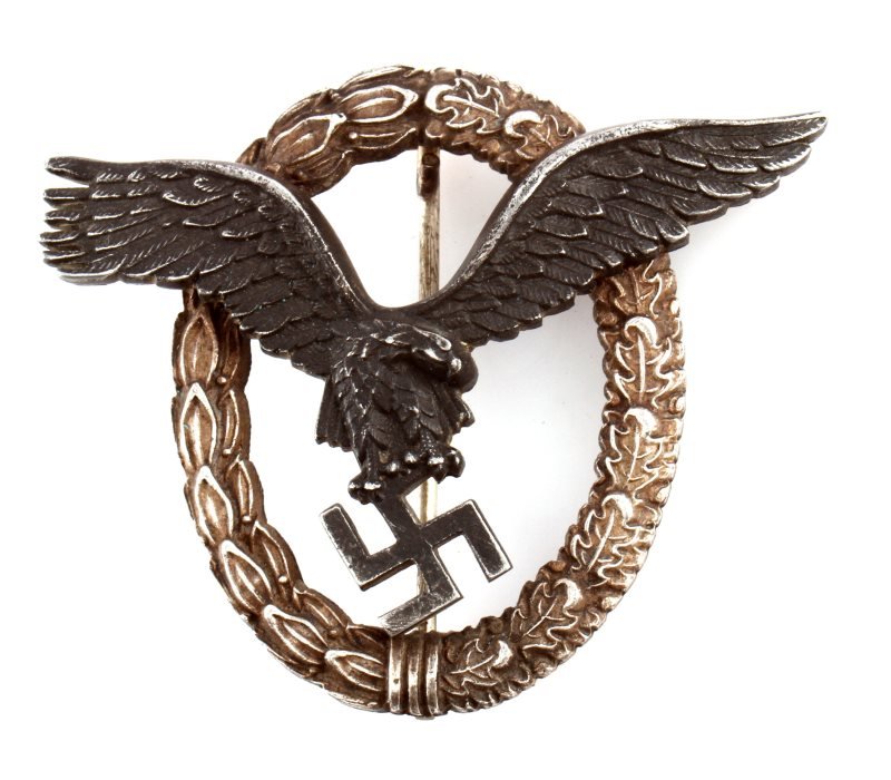 WWII THIRD REICH LUFTWAFFE PILOT BADGE BY ASSMANN: A Luftwaffe pilot's badge made by Assmann. Two piece construction with two rivets on wings holding the eagle to the wreath. Assman trademark on the eagle's reverse. Rear stickpin with flat "C" catch a
