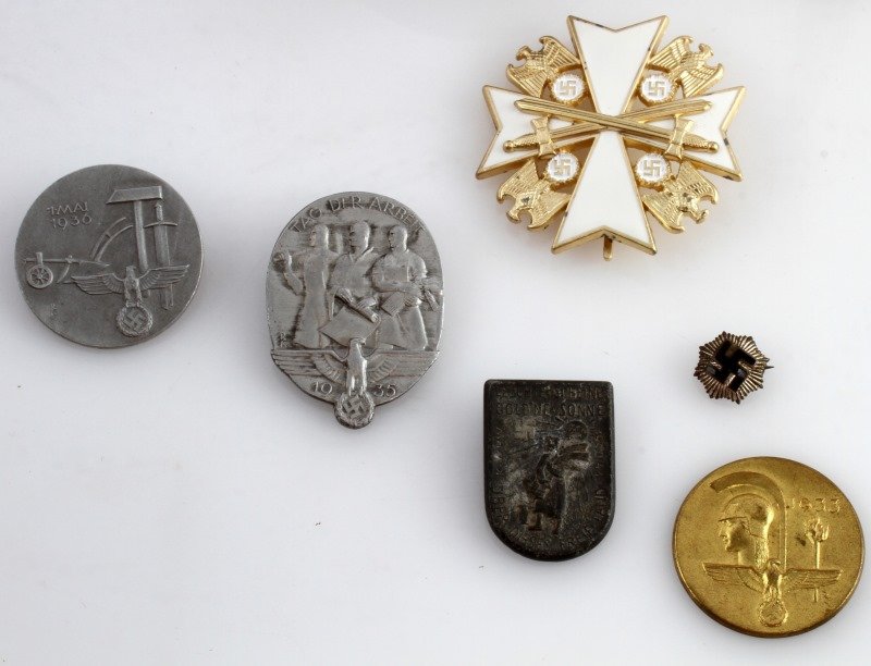 WWII GERMAN MIXED LOT TINNIES TRENCH ORDER BADGE: WWII Third Reich German lot. Includes: four German Labor Day tinnies (one clasp detached), German Eagle Order 2nd class (900/L50), 1938 Nazi marked 7.62 shell, tiny swastika pin (Ges. Gesch), a tooled