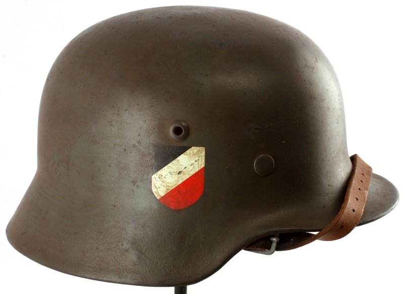 GERMAN WWII M40 DOUBLE DECAL HELMET: German WWII double decal M40 helmet. The exterior has a green painted finish, with a Wehrmacht decal on one side and the National shield on the other. Eight finger leather liner with five holes in eac