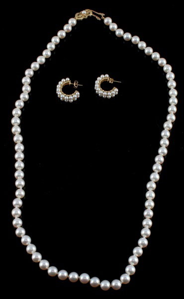 MIKIMOTO PEARL NECKLACE AND EARRING SET: A Mikimoto pearl necklace and earring set. the necklace is 23 inches long and has an 18 karat gold clasp. Pearls measure 7 mm each. The earrings have 3mm pearls and one of their butterfly backs bears 