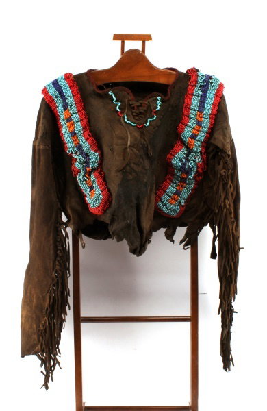 19TH CENTURY PLAINS INDIAN WAR SHIRT: What makes this particular War Shirt unique it was used in battle and to hunt, clear patination in the leather of bow to the front and quiver on reverse. Heavy bead work on raised rawhide. Unattribute