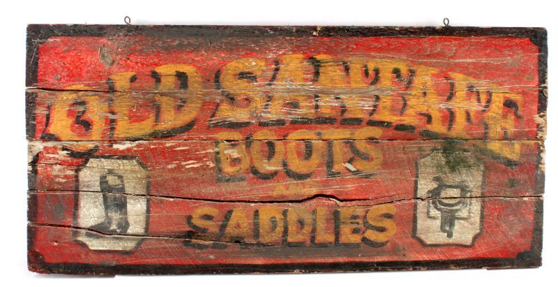 ANTIQUE BOOT & SADDLE TRADE SIGN OLD SANTAFE: Antique wooden trade sign for a saddle and boot store. The sign reads: "Old SantaFe Boots and Saddles". Single sided. The sign has some fading and cracks, but still legible and original. Measures 15.5