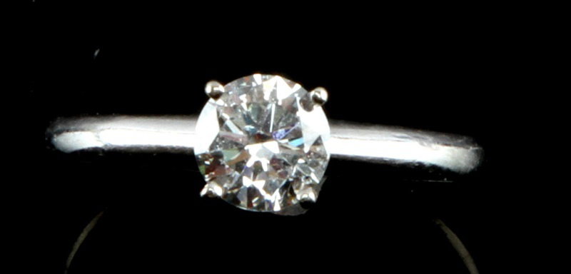 14 K WHITE GOLD SOLITAIRE ROUND .7 CT SIZE 6: White gold solitaire with .7 ct round cut diamond. The stone is an F/G color with clarity of SI2/I1. The inclusions are clear making it difficult to see with the naked eye, but are still visible. A ne