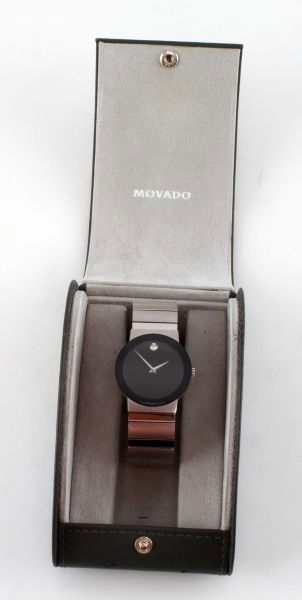 MOVADO STELO MUSEUM STAINLESS/SAPPHIRE GLASS WATCH: A Movado Stelo museum-dial men's watch in stainless steel with sapphire glass crystal and black dial. Refernce # 99 c6 1881. 33mm case and 20mm bracelet. Needs a battery replacement. Includes original
