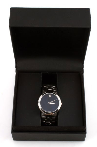 MOVADO STAINLESS STEEL MUSEUM WATCH BLUE DIAL: Movado classic Museum watch on stainless steel bracelet. Blue dial. Quartz movement . Appears to be running. Includes original box. Bracelet has minor signs of use, but overall very good condition.