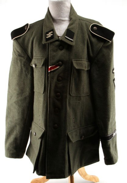 POST-WWII GERMAN TUNIC W SS LEIBSTANDARTE INSIGNIA: Post-War German Tunic with SS Leibstandarte Insignia green wool fabric, with full set of buttons marked "BJ 42" on their obverse, Leibstandarte insignia marked "Adolf Hitler" on left sleeve towards bo