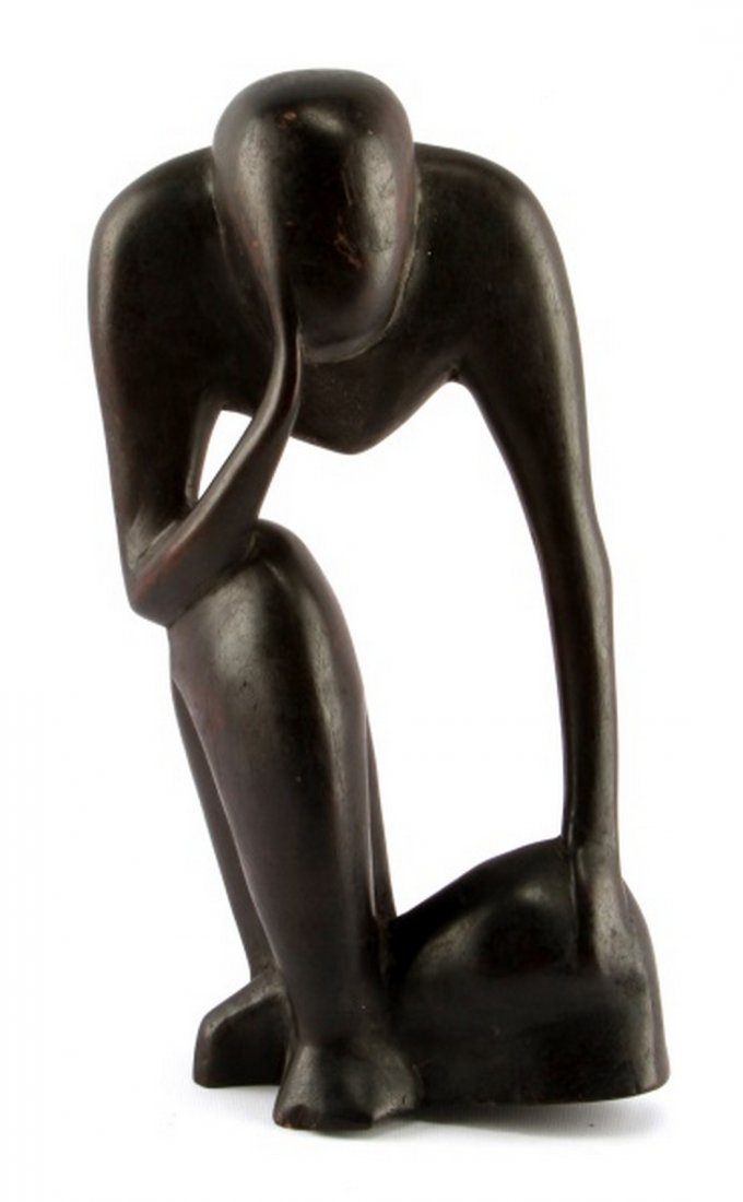 AFRICAN INSPIRED MODERN ART FIGURAL WOOD SCULPTURE: A 14.75 inch tall sculpture of a sitting man. Hand carved out of ebonized wood. In good condition with some surface scuffs.