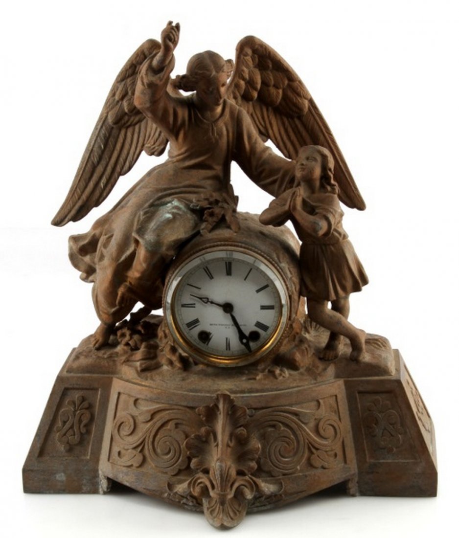 LYNDHURST PLANTATION SETH THOMAS MANTLE CLOCK: Metal angel and child, Circa 1876, matte finish as opposed to gilt, stands 16.5 inches. Porcelain face is free of cracks and thick glass cover is damage free, the face is marked Seth Thomas Sons & Co.
