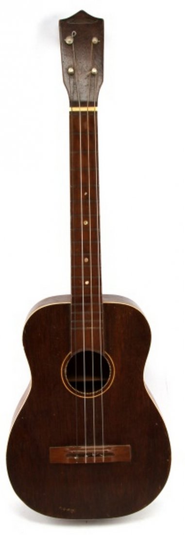 VINTAGE 1950S MARVELTONE BARITONE UKULELE W/ BAG: A MArveltone baritone ukulele with original gig bag. Measures 31 inches long. In good playing condition with some signs of age in the form of lacquer checking and various marks as expected.