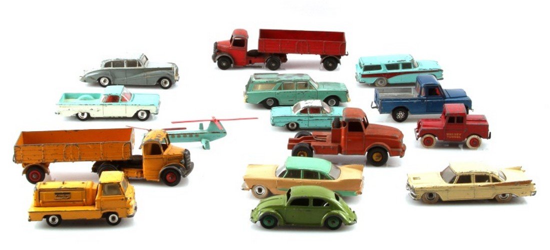 LOT OF 15 ASSORTED VINTAGE DINKY TOY VEHICLES: Items are in fair condition missing paint with some scratches. Items include but not limited to are Tow truck, helicopter pickup truck and various cars.